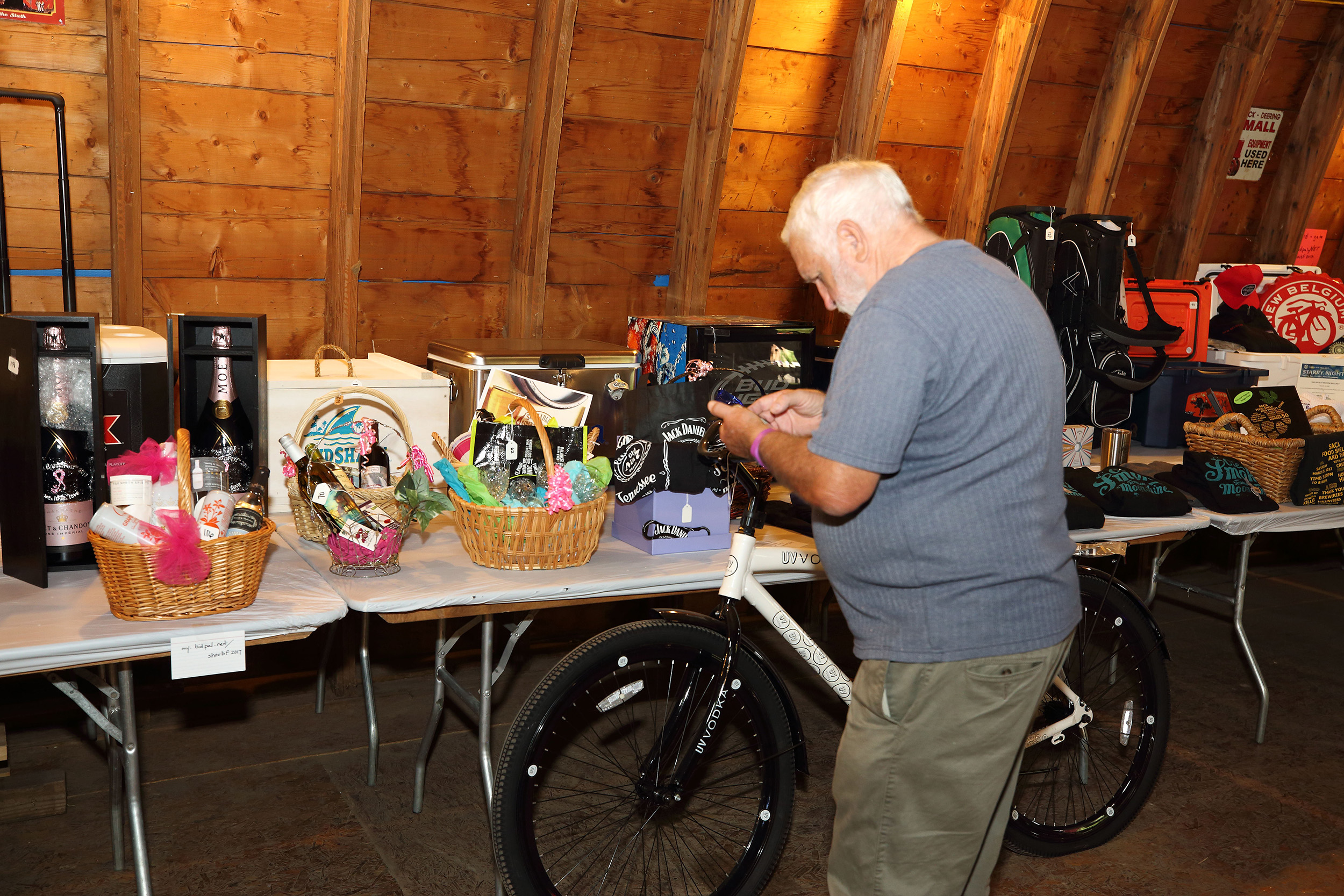 sam bidding on auction items from his phone